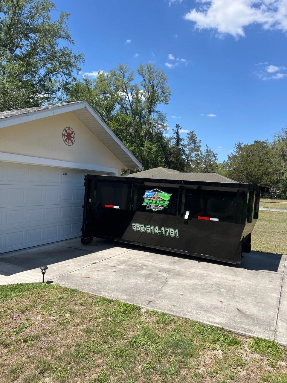 15-yard HDR Dumpster in charcoal grey placed on a residential driveway