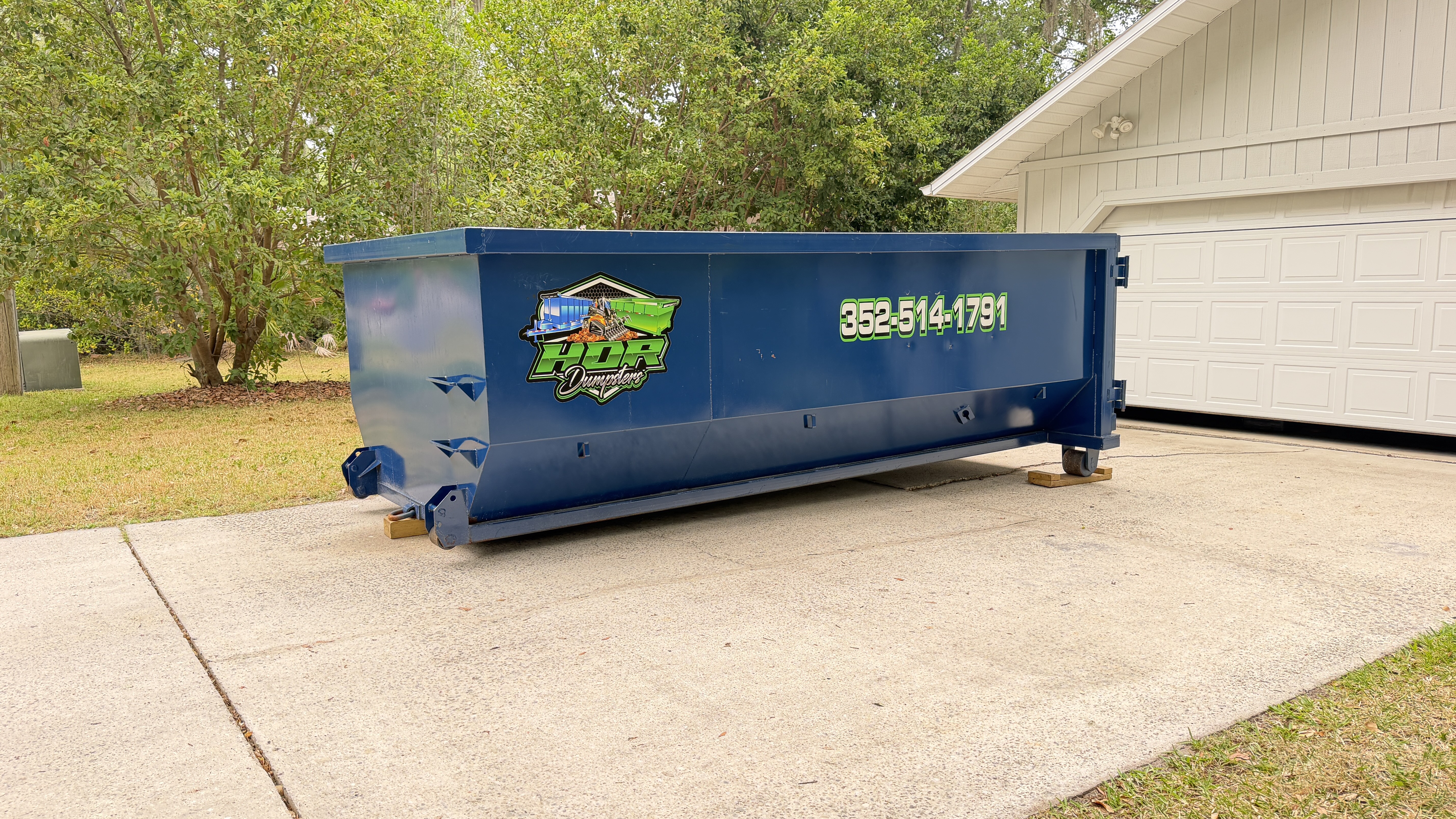 15-yard HDR dumpster placed on a residential driveway in Alachua County